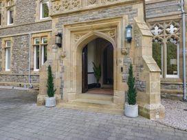 An entrance with a stone door and planters at Brettargh Holt Mansion near Levens