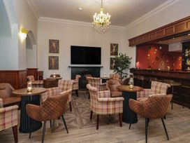 A lounge with chairs and tables at Brettargh Holt Mansion near Levens