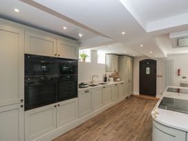 A kitchen with cabinets and ovens at Brettargh Holt Mansion near Levens