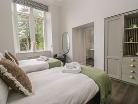 A bedroom with two beds and a mirror at Brettargh Holt Mansion near Levens