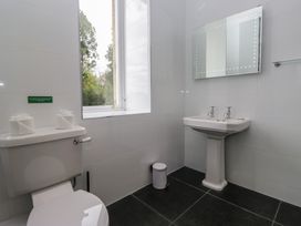 A bathroom featuring a toilet and a sink at Brettargh Holt Mansion near Levens