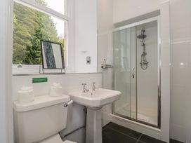 A bathroom with a toilet sink and shower at Brettargh Holt Mansion near Levens