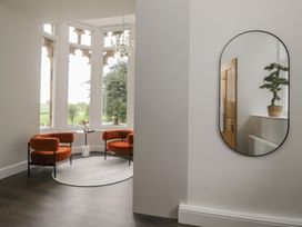 A living room with two chairs and a plant at Brettargh Holt Mansion near Levens