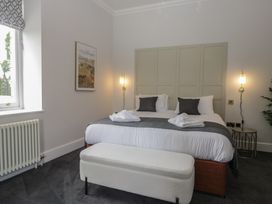 A bedroom with a bed and artwork at Brettargh Holt Mansion near Levens