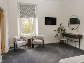 A living room with armchairs and a console table at Brettargh Holt Mansion near Levens