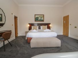 A bedroom with a bed and desk at Brettargh Holt Mansion near Levens