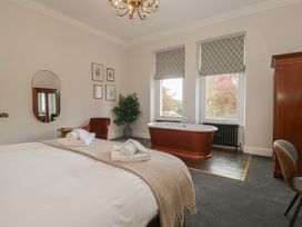 A bedroom with a bed and bathtub at Brettargh Holt Mansion near Levens