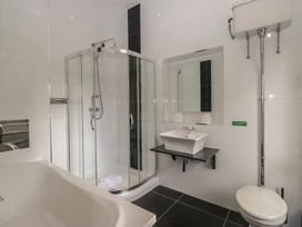 A bathroom with a shower, bathtub, sink, and toilet at Brettargh Holt Mansion near Levens