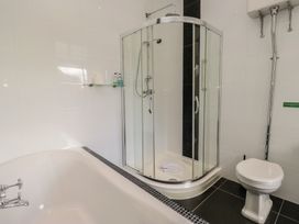 A bathroom with a bathtub, shower, and toilet at Brettargh Holt Mansion near Levens