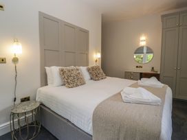 A bedroom with a double bed and wardrobe at Brettargh Holt Mansion near Levens