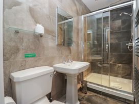 A bathroom with a toilet, sink, and shower at Brettargh Holt Mansion near Levens