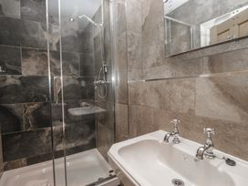 A bathroom with a shower and bathtub at Brettargh Holt Mansion near Levens