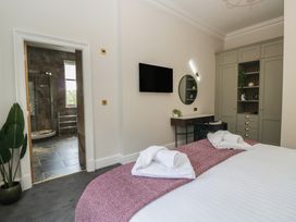 A bedroom with a bed and a shower area at Brettargh Holt Mansion near Levens