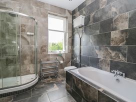 A bathroom with shower and bathtub at Brettargh Holt Mansion near Levens