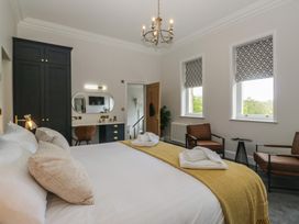 A bedroom with a bed and chairs at Brettargh Holt Mansion near Levens