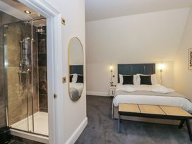 A bedroom with a shower and mirror at Brettargh Holt Mansion near Levens