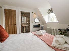 A bedroom with a bed and a sink area at Brettargh Holt Mansion near Levens