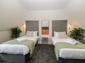 A bedroom with two beds and a painting at Brettargh Holt Mansion near Levens
