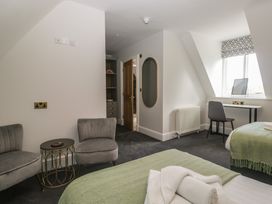 A bedroom with two beds and a desk at Brettargh Holt Mansion near Levens