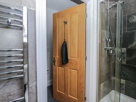 A bathroom with a door and a towel radiator at Brettargh Holt Mansion near Levens