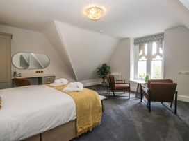 A bedroom with a bed and chairs at Brettargh Holt Mansion near Levens