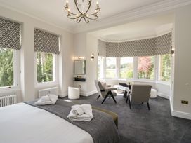 A bedroom with a bed and seating area at Brettargh Holt Mansion near Levens