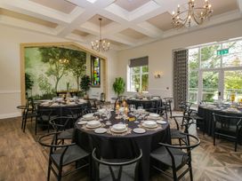 A dining room with tables and chairs at Brettargh Holt Mansion near Levens