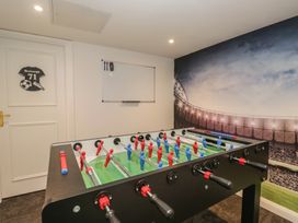 A foosball table and whiteboard in a game room at Brettargh Holt Mansion near Levens