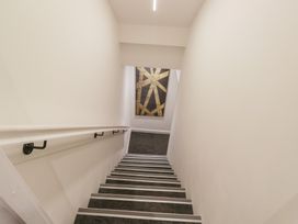 A staircase with a handrail and artwork at Brettargh Holt Mansion near Levens