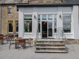 An outdoor area with chairs and tables at Brettargh Holt Mansion near Levens