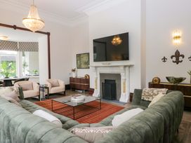 A living room with a fireplace and sofa at Brettargh Holt Mansion Sleeping 48 near Sizergh, Cumbria