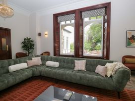 A living room with a green sofa and coffee table at Brettargh Holt Mansion Sleeping 48 near Sizergh, Cumbria