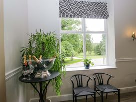 A dining area with champagne, glasses, and chairs at Brettargh Holt Mansion Sleeping 48 near Sizergh, Cumbria