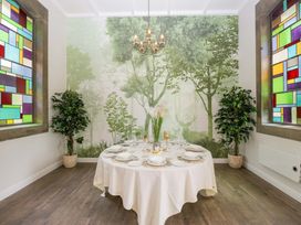 A dining room with a table set for a meal at Brettargh Holt Mansion Sleeping 48 near Sizergh, Cumbria