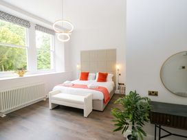 A bedroom with a bed and windows at Brettargh Holt Mansion Sleeping 48 near Sizergh, Cumbria