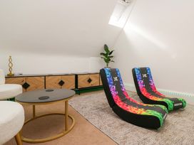 A game room with gaming chairs and a coffee table at Brettargh Holt Mansion Sleeping 48 near Sizergh, Cumbria