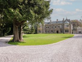 A house with trees and a gravel driveway at Brettargh Holt Mansion 32 near Levens