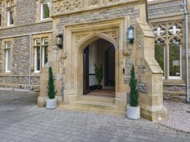An entrance with a stone door frame and potted plants at Brettargh Holt Mansion 32 near Levens