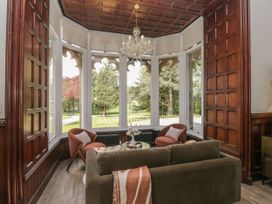A living room with a chandelier and seating area at Brettargh Holt Mansion 32 near Levens