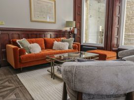 A living room with a sofa coffee table and armchair at Brettargh Holt Mansion 32 near Levens