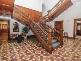 An entryway with a staircase and seating area at Brettargh Holt Mansion 32 near Levens