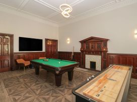 A game room with a pool table and shuffleboard table at Brettargh Holt Mansion 32 near Levens