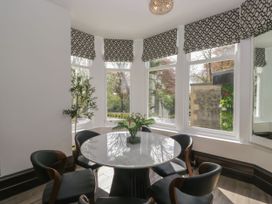 A dining room with a round table and chairs at Brettargh Holt Mansion 32 near Levens