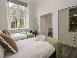 A bedroom with twin beds and a wardrobe at Brettargh Holt Mansion 32 near Levens