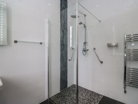 A bathroom with a shower and towel rail at Brettargh Holt Mansion 32 near Levens