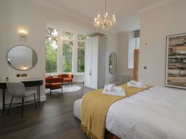 A bedroom with a bed and seating area at Brettargh Holt Mansion 32 near Levens