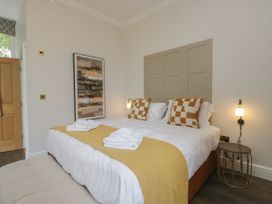A bedroom with a bed and artwork at Brettargh Holt Mansion 32 near Levens