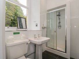 A bathroom featuring a shower, sink, and toilet at Brettargh Holt Mansion 32 near Levens