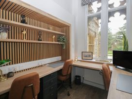An office with a desk, chairs, and shelves at Brettargh Holt Mansion 32 near Levens