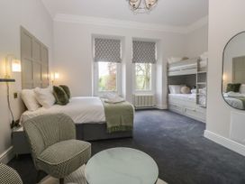 A bedroom with a double bed and bunk bed at Brettargh Holt Mansion 32 near Levens